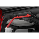 inside the open door of a jeep, a red metal grab bar is installed