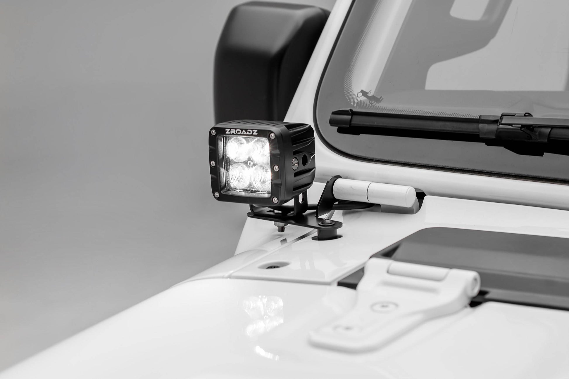 a pod light mounted on a white vehicle