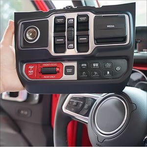 a person’s hand holding a switch panel showing off several buttons and features
