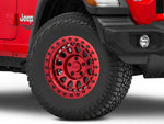 A red jeep wrangler with a black red shiny wheel