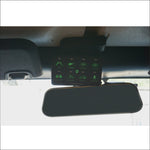 a control system with lit green buttons installed by a rearview mirror