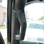 a 4 button panel installed in a vehicle’s grab handle