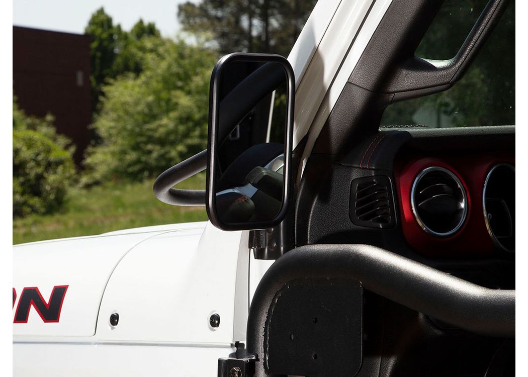 a white rubicon with a rounded rectangular mirror installed