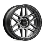 a black wheel with the KMC logo on it