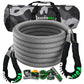 a gray coiled recovery rope sits in front of it’s packaging and carrying case