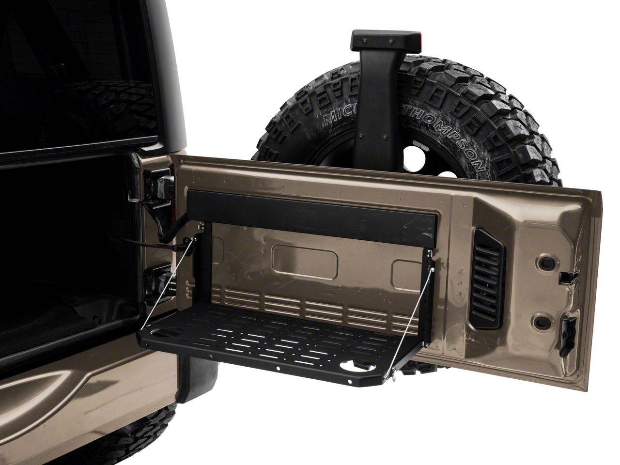 the rear door of a bronze vehicle is open to reveal an installed tailgate table which has been opened