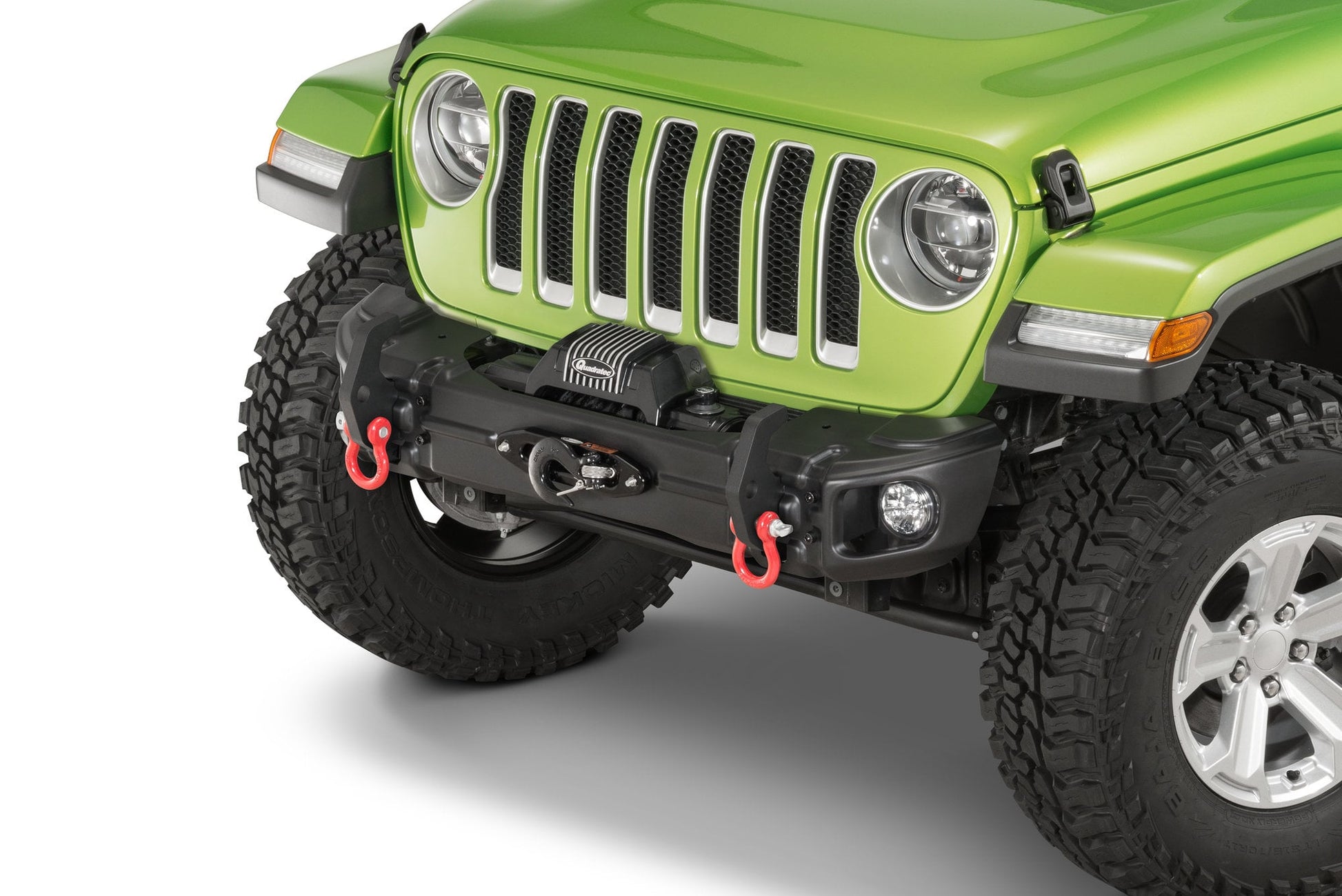 the front of a green jeep with the arcus bumper installed and feature hooks