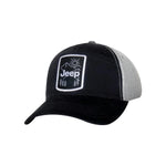 a black and gray hat with a black and white badge showing a white jeep logo and a simply mountain design